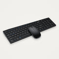 Black full-size Bluetooth keyboard and mouse set on a light neutral background