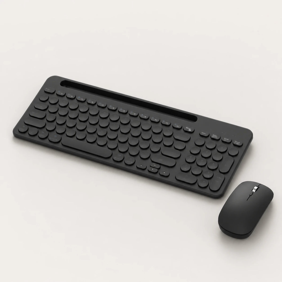 Black multi-device keyboard and mouse set on a light neutral background