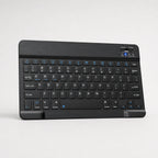 Ultra-slim Bluetooth keyboard and mouse set on a light neutral background